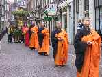 nuns walking before Buddha